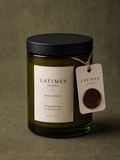 Latimer Goods Pine Forest Candle in olive green glass jar with ivory label and oxblood wax seal tag
