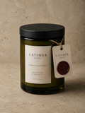 Latimer Goods Tobacco & Honey Candle in olive green glass jar with ivory label and oxblood wax seal tag