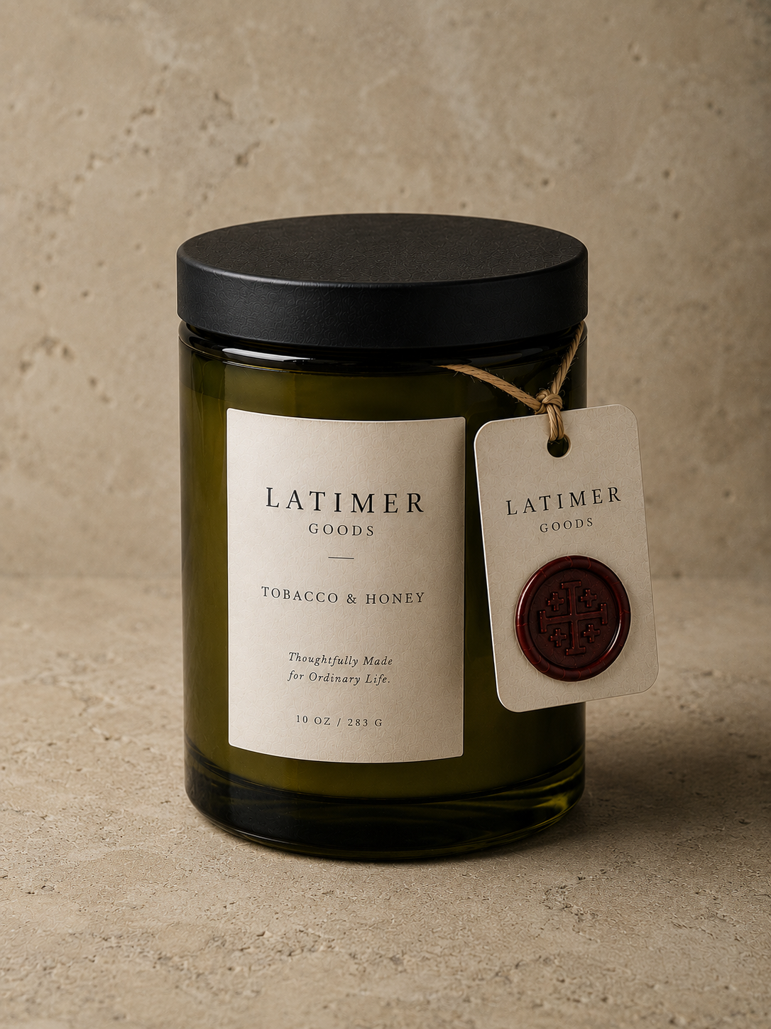 Latimer Goods Tobacco & Honey Candle in olive green glass jar with ivory label and oxblood wax seal tag